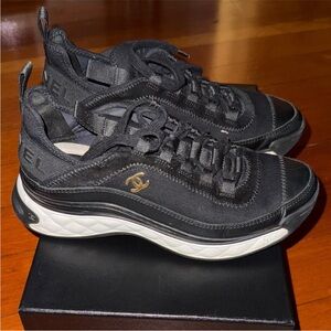 Women Chanel Black Sneakers have been worn